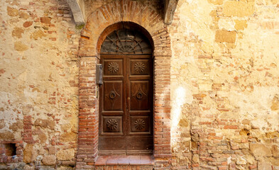 Fototapeta na wymiar Antique door in Pienza, Tuscany, Italy