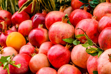 Many pomegranates for sale at the market. Fruit background