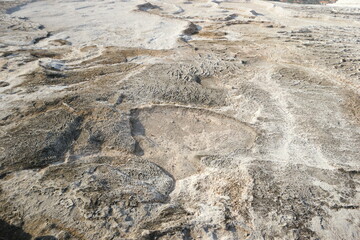 Brown travertine terrace surface. Calcium deposits from thermal springs. Pamukkale, Turkey.