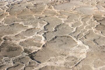 Fototapeta na wymiar Close up of limestone travertine in Pamukkale. Abstract background with stone ripples of calcium.