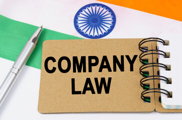 Against the background of the flag of India lies a notebook with the inscription - COMPANY LAW