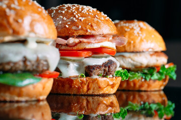 Juicy beef Burgers on a black background.