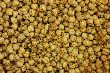 Pile of roasted chickpeas. Roasted yellow chickpea background.