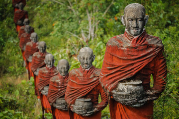 Hundreds of old statues of Buddhist monks collecting alms surround the Win Sein Taw Ya Buddha in Mawlamyine, Myanmar (Burma).