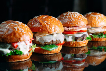 Juicy beef Burgers on a black background.
