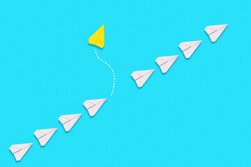The concept of independence and individuality. A yellow paper airplane flies out of the queue of...
