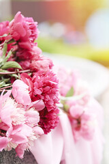 Delicate pink peonies bouquet background with copy space. Spring, summer bright concept on fresh green background