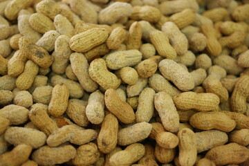 Pile of peanuts in shells close up. Organic peanuts background.