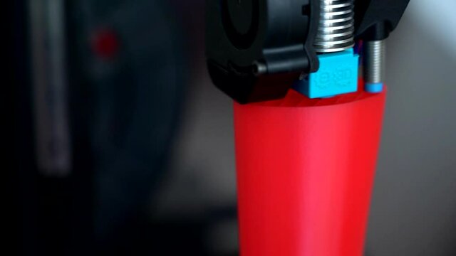 3D printer printing plastic last shoe prototype from red filament, real time