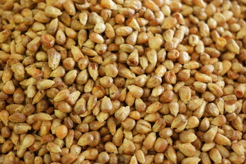 Heap of peeled peanuts close up. Roasted peeled peanuts background.