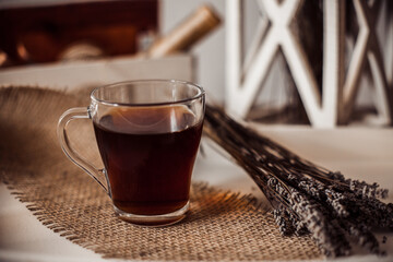 A cup of tea on a tray with lavender