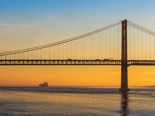 View over the Tagus River during sunrise and 25 de Abril Bridge