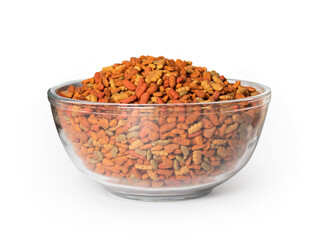 Kibbles in large bowl. Oversized and overfilled glass dish with dry pet for dogs or cats. A variety pack of flavors and colors in small pieces of ground up meal. Isolated on white.