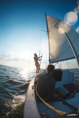 A man and a woman are traveling on a sailing yacht.