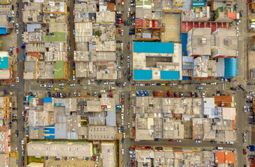 Top aerial view of a Bogota city with colorful roofs and cars during a daytime - Powered by Adobe