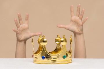 Struggle for the first place. Lust for power concept. A female hands is trying to get a golden...
