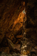 Light illuminating a hidden limestone cave in Gozo, Malta