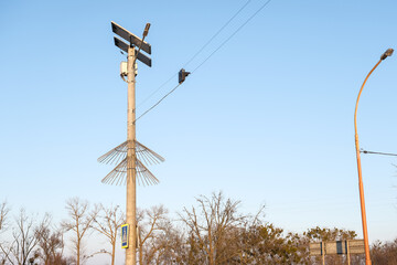 Street traffic lights powered solar cell panel installed on country road on blue sky background