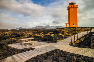 Svortuloft Lighthouse with a view of Snæfellsjokull behind and car parked in Iceland