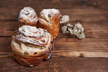 Traditional easter cake Kraffin stands on wooden table against a dark background.
