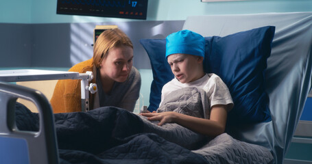 Mother discussing illness with son in clinic ward