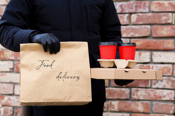 Home delivery with gloves and mask. Delivery to coronavirus. Safe delivery of groceries. Food. The...