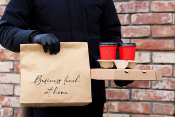 Food delivery home wearing a mask and gloves.Safe food delivery.Pizza delivery to your home and...