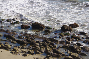 High angle view of the rocky water’s edge of the Pacific ocean near Goleta southern California on a winter day 