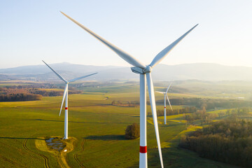 Panoramic view of wind farm or wind park, with high wind turbines for generation electricity with...