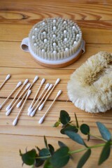 Obraz na płótnie Canvas Body skin care. Natural bristle brushes, sea salt, body scrub, natural stone roller, brush on wooden background