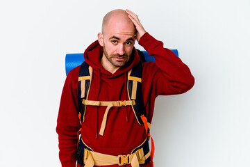 Young caucasian backpacker bald man isolated on white background being shocked, she has remembered...