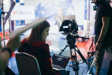 Director at work on the set.  Shooting shift, equipment and group. Modern photography technique.