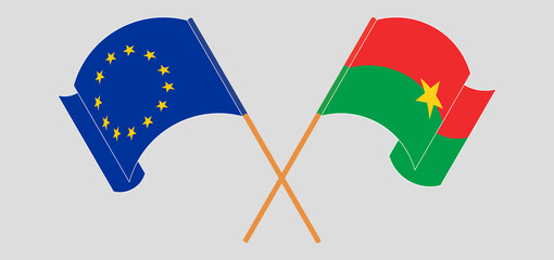 Crossed and waving flags of the EU and Burkina Faso