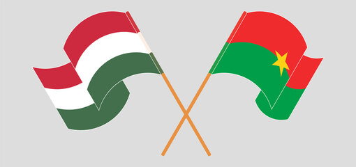 Crossed and waving flags of Hungary and Burkina Faso