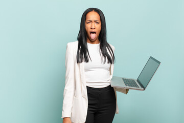 young black woman feeling disgusted and irritated, sticking tongue out, disliking something nasty...