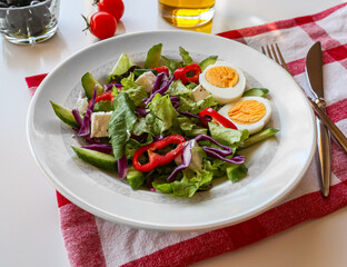fresh mixed salad with napkin and white background