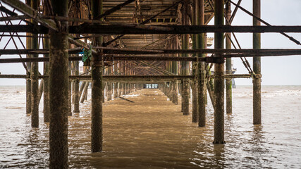 Fototapeta premium The rusty iron construction on the downside of a pier