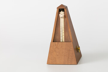 vintage wood metronome closeup, isolate and on a plain background