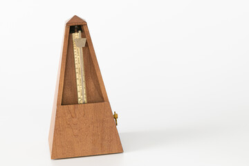 vintage wood metronome closeup, isolate and on a plain background