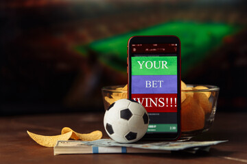 Mobile app for online betting and soccer ball with snacks. Gambling and bet concept.