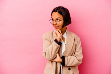 Young business mixed race woman isolated on pink background smiling happy and confident, touching chin with hand.