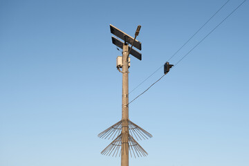 Street traffic lights powered solar cell panel installed on country road on blue sky background