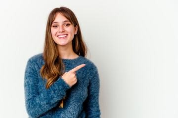 Young caucasian cute woman isolated on white background smiling and pointing aside, showing something at blank space.