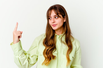 Young caucasian cute woman isolated on white background pointing with finger at you as if inviting come closer.