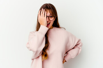 Young caucasian cute woman isolated on white background having fun covering half of face with palm.