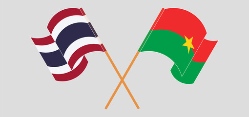 Crossed and waving flags of Thailand and Burkina Faso