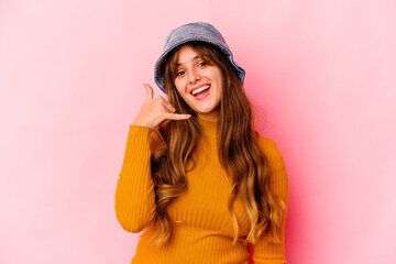 Naklejka premium Young caucasian woman wearing fishermans hat isolated showing a mobile phone call gesture with fingers.