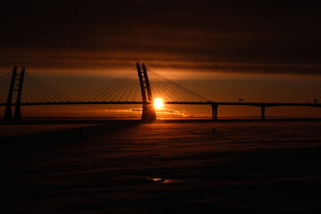 Fototapeta na wymiar winter sunset on the background of the bridge