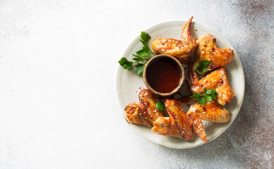 Grilled hot and spicy chicken wings on a plate