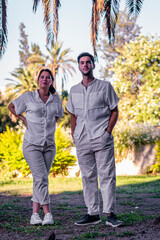 young man and woman couple in outdoor city park with white and light clothes in spring summer 2021